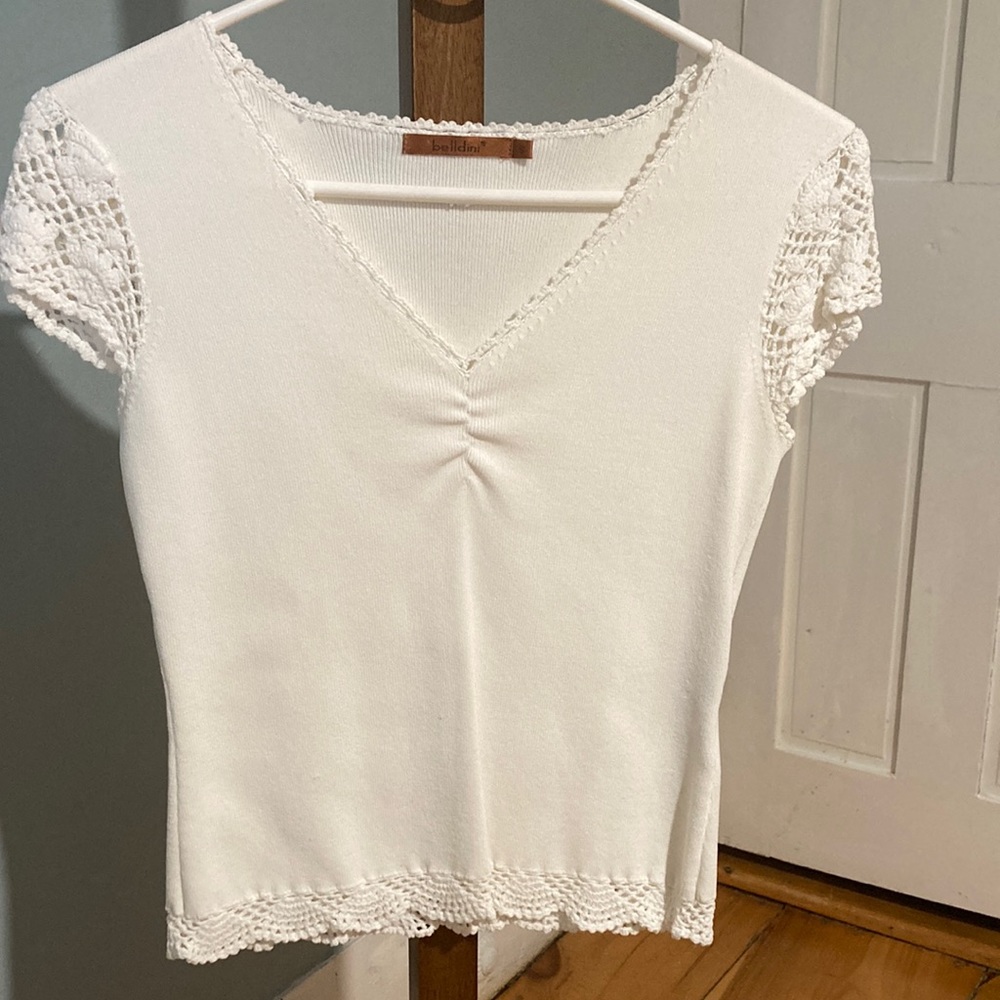 Pretty little white v-neck sweater/top with delicate enhancing details.